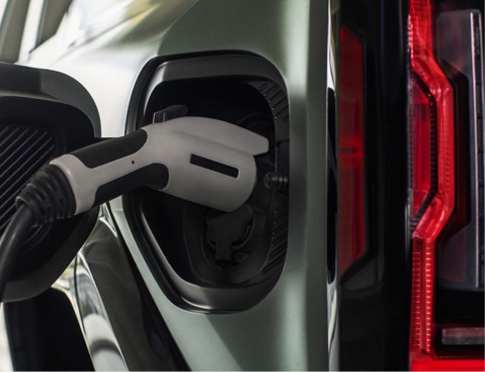 Close up of charging port with charger plugged in on a GMC Hummer EV SUV - Lewiston GMC in Lewiston ID